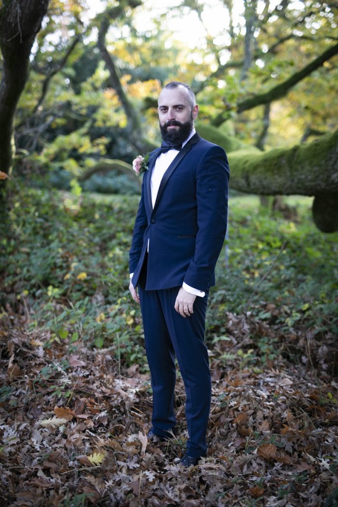 groom standing under trees in Mount Juliet Estate Wedding -