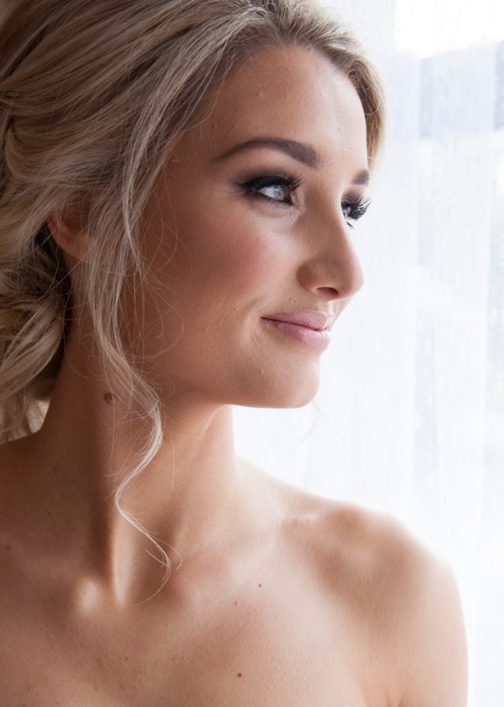 Close-up image of the bride's face looking out the window