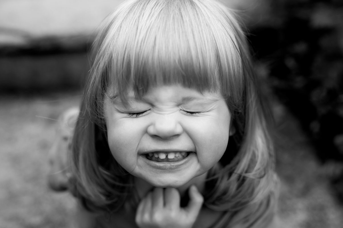 Black-and-white photo of a girl with her eyes closed